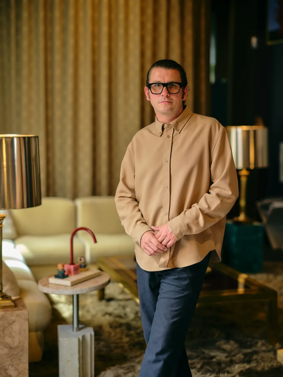 Architect Fabian Freytag in a living room, his Dornbracht Atelier tap on a side table beside him